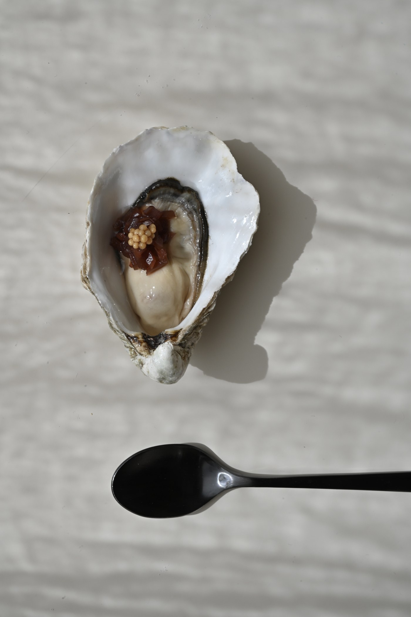 Single oyster with shallot and mustard seed