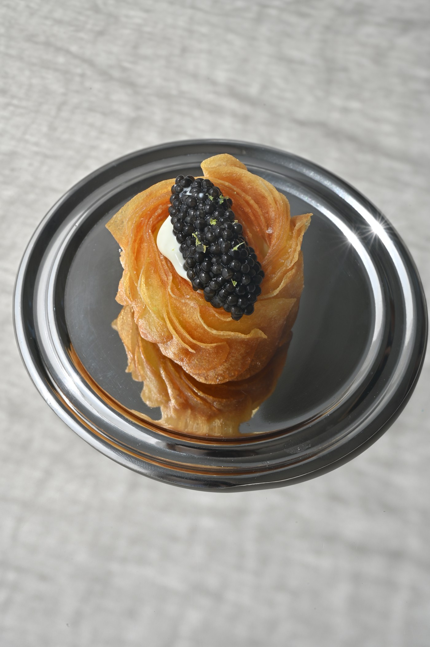 Crispy potato roll with caviar and crème fraîche